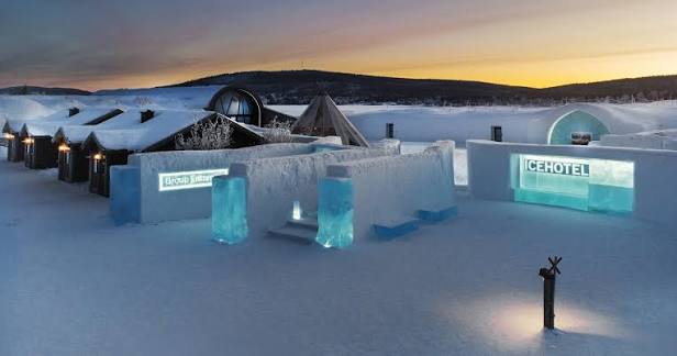Low ice and snow building standing beside a frozen river in Swedish Lapland