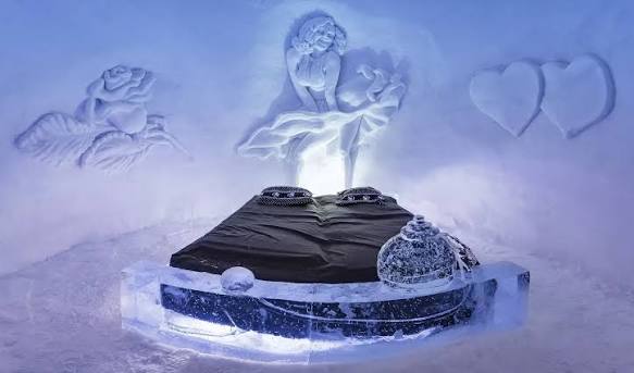 Snow hotel building on a shore above a northern Norwegian fjord