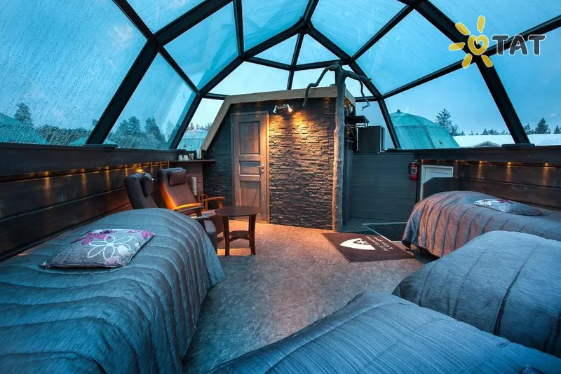 Glass igloos spaced across a snow-covered clearing near Rovaniemi