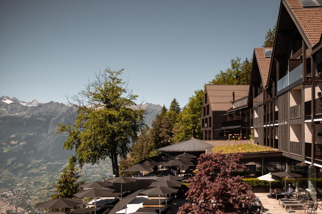 Hotel terrace on the edge of a slope above a wide alpine valley in South Tyrol