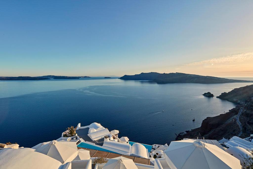 White stepped terraces cut into the caldera wall at Oia on Santorini