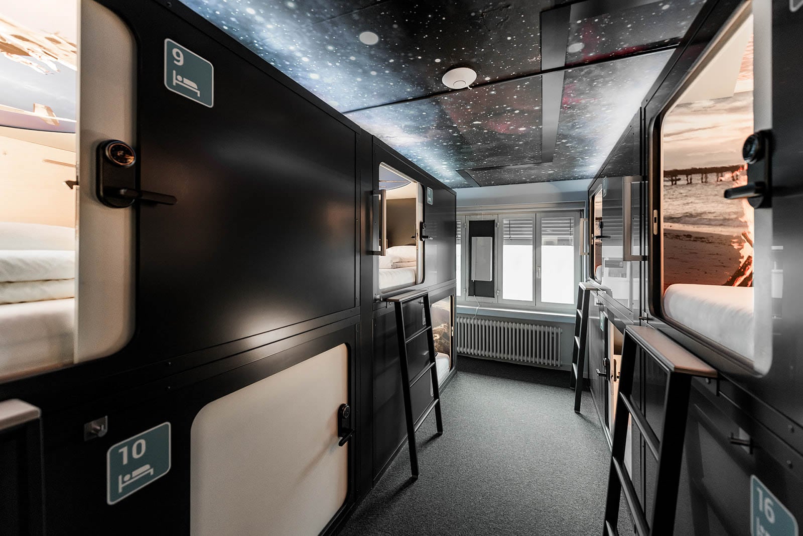 Interior corridor of a capsule hotel with stacked sleeping units
